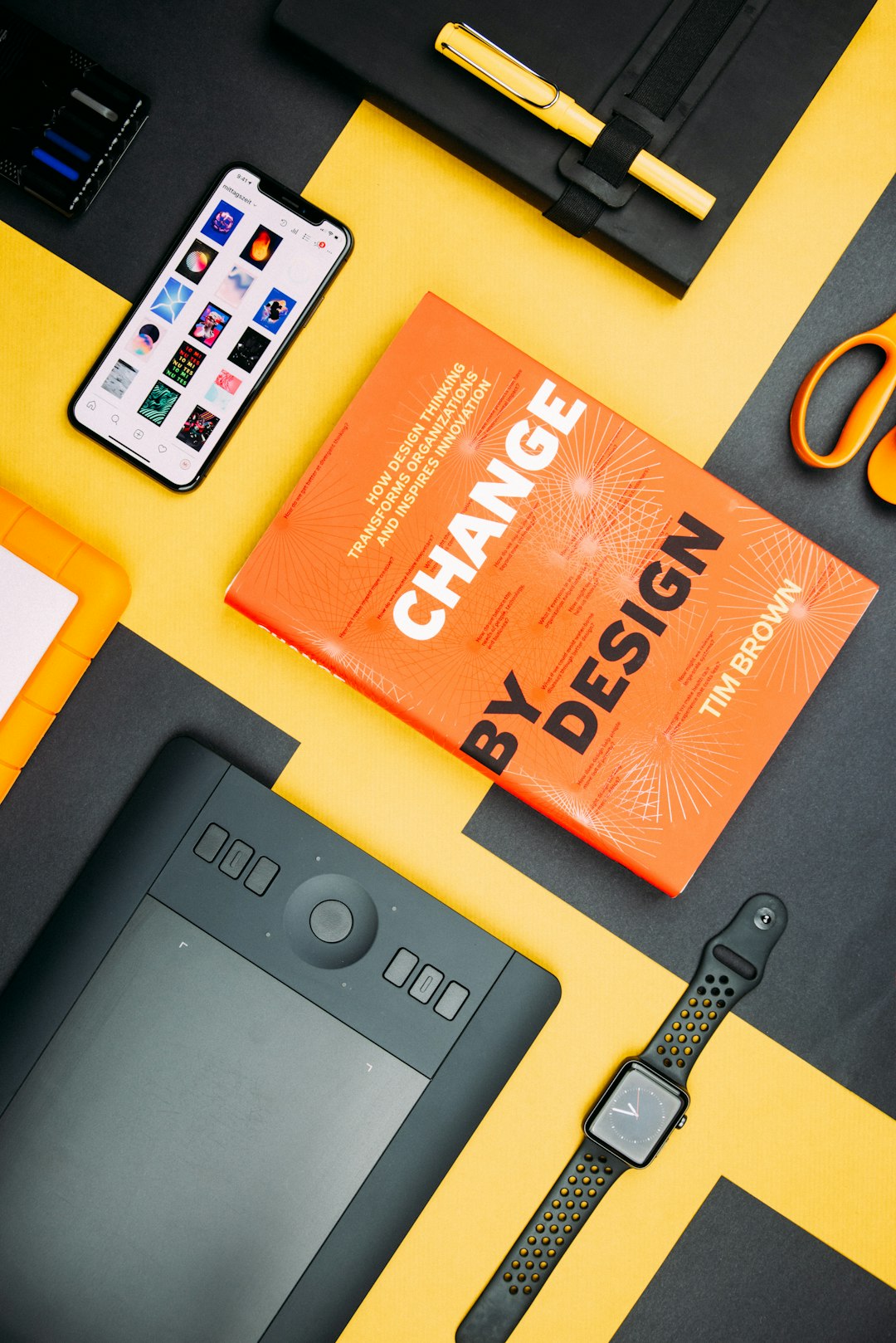 about-us-02 change-by-design-by-tim-brown-book-beside-smartphone-iyanci0cyrk